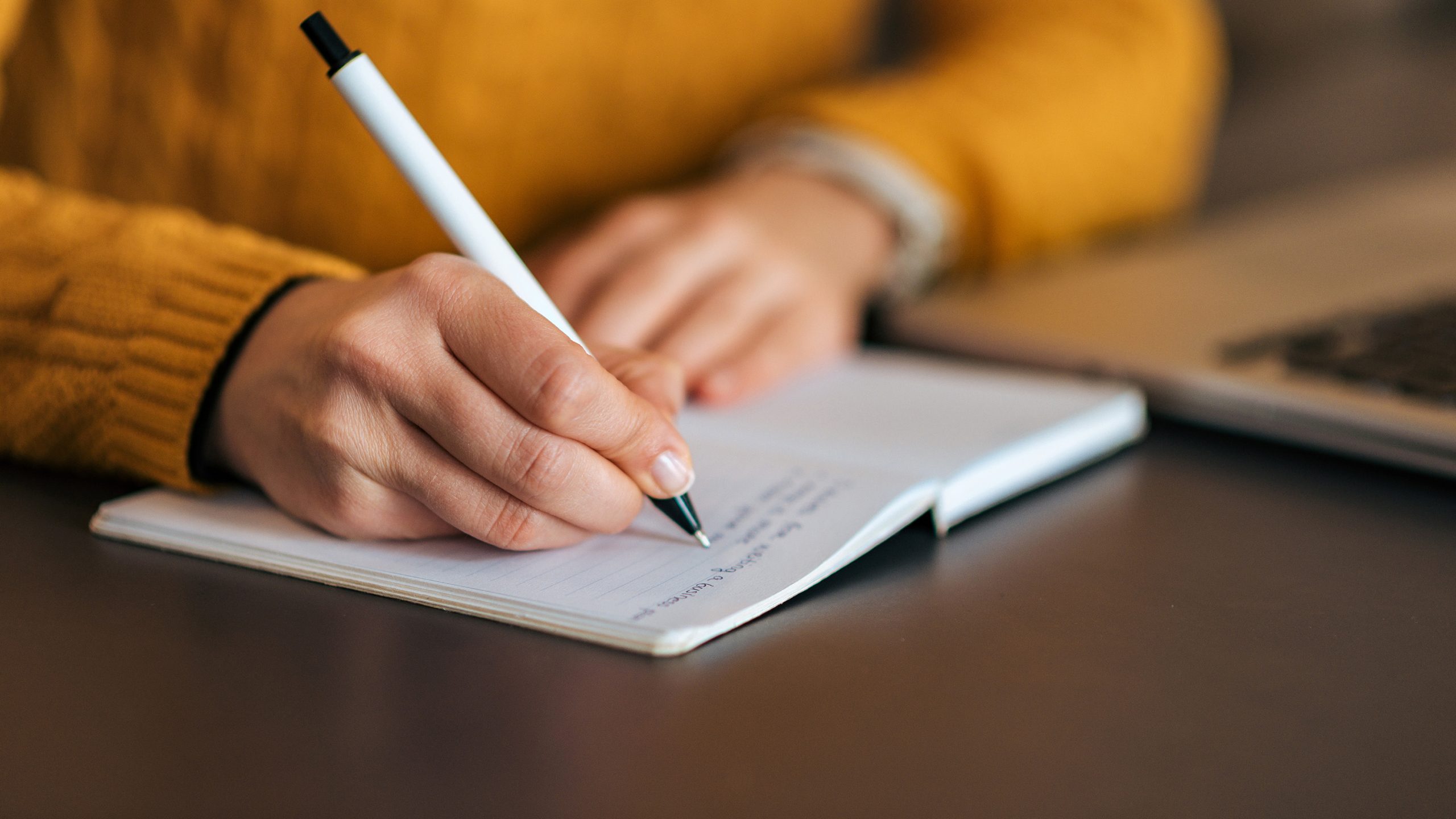 Person writing in notebook