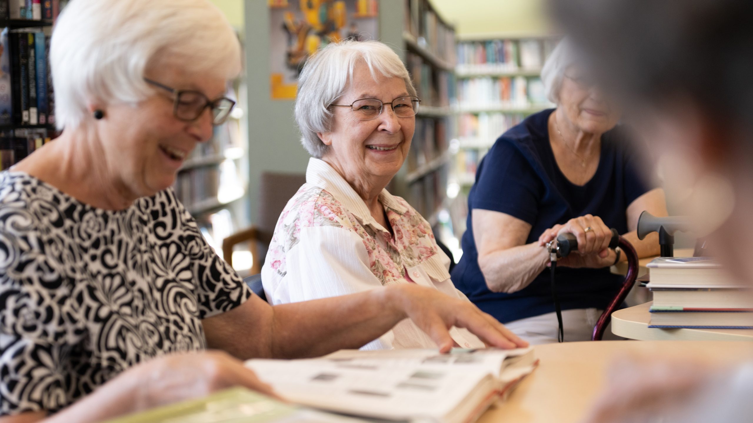 Senior woman with community in library