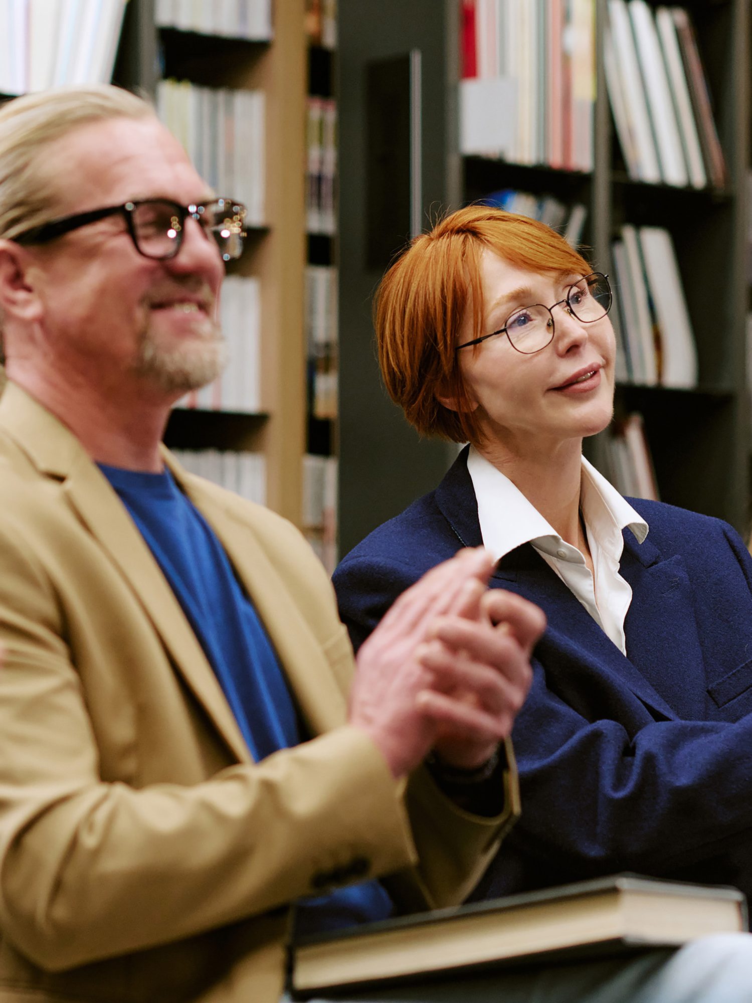 Adults giving applause at library event