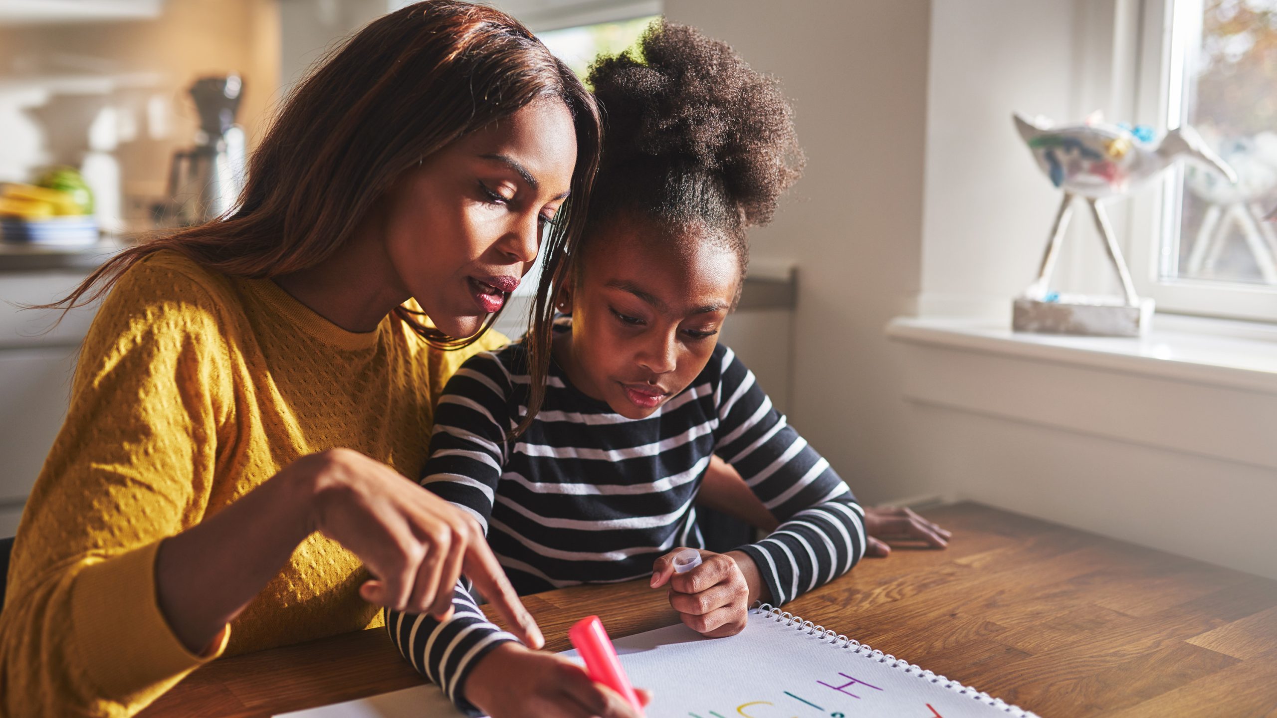 African American mentoring young girl in library