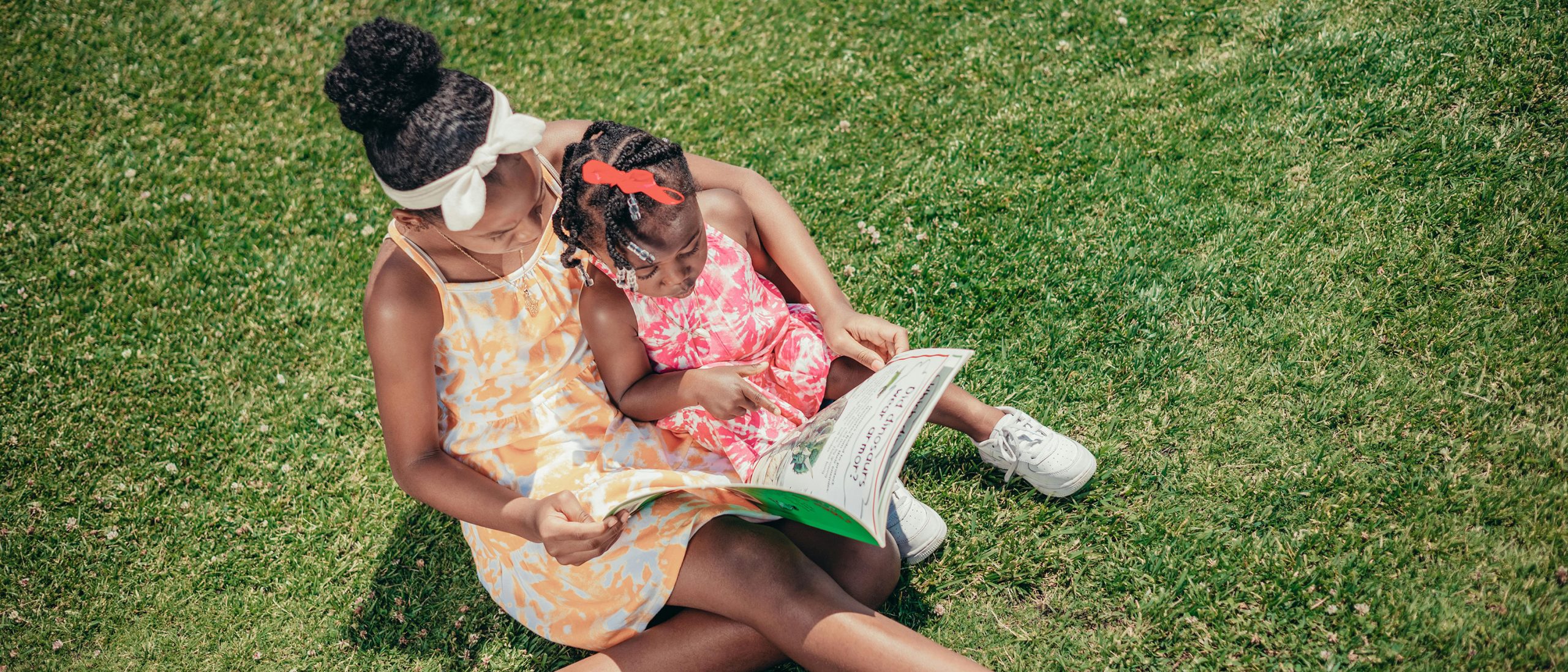 Adult woman reading to young girl
